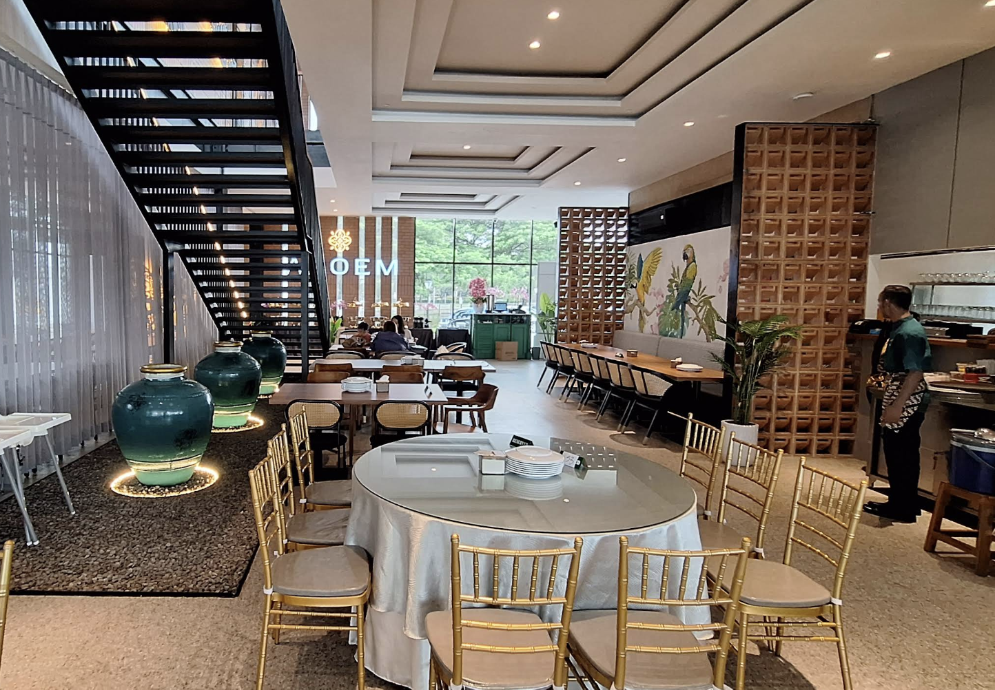 A dining room with round tables and warm wooden details.